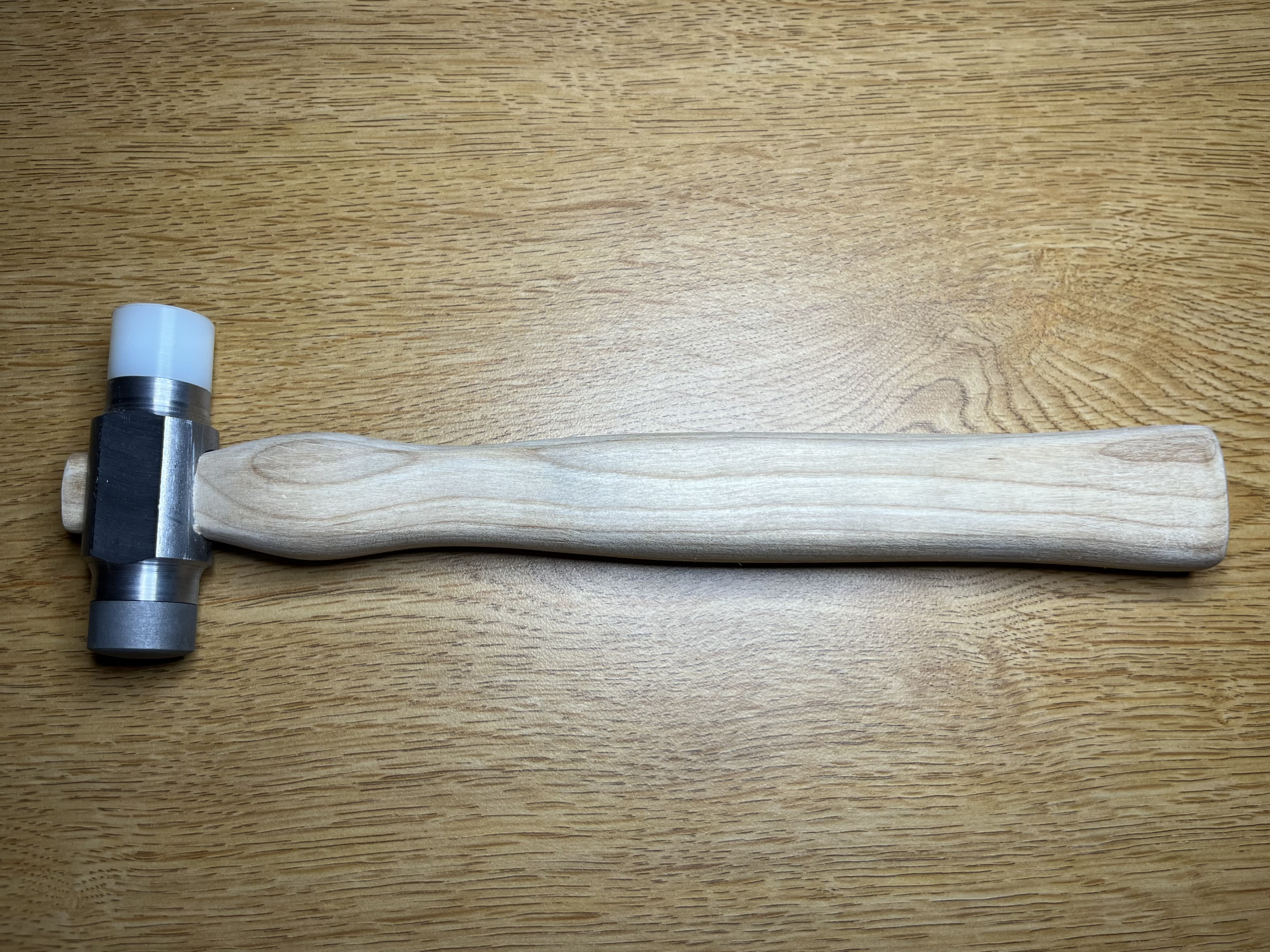 E4 hammer with a heat treated hard face and a nylon soft face